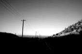 An empty desert road under a pale sky