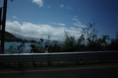 A road running along the coast under heavy cloud