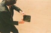 A person holding a camera out in the dunes