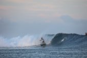 Surfers sitting in the lineup beyond the break