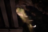 Headlights cutting through the dark on a bluff
