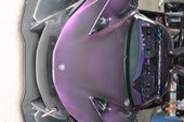 The nose of a purple supercar