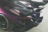 The rear wing of a purple supercar