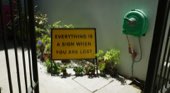 A yellow sign reading everything is a sign when you are lost