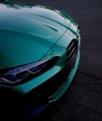 The nose of a teal BMW