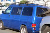 A blue van parked at the kerb
